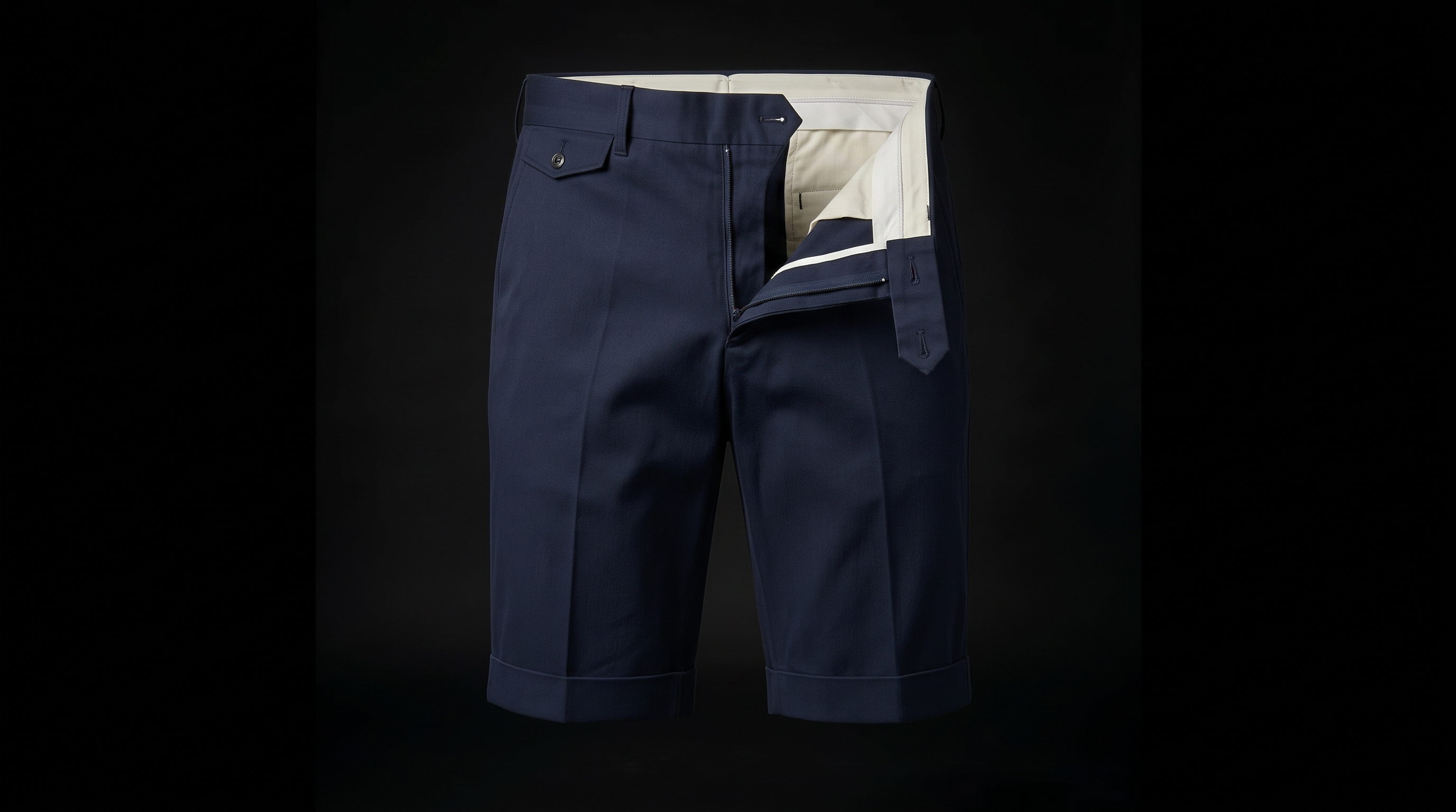 The navy chino shorts unbutton and the front panel folds out, showing the ecru pocket bag and inner waistband